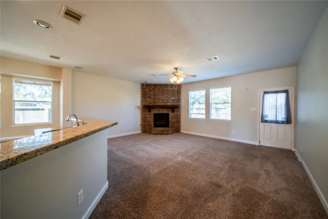 a living room with granite countertop furniture and a fireplace