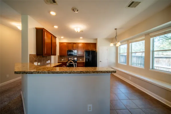 a view of a kitchen with a sink and a large window