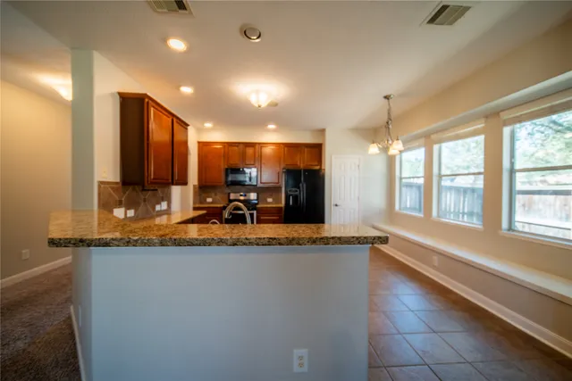 a view of a kitchen with a sink and a large window