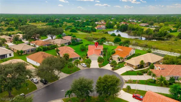 an aerial view of residential houses with outdoor space and street view