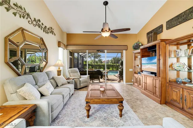 a living room with furniture ceiling fan and a rug