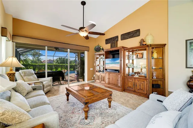 a living room with furniture a rug and a chandelier