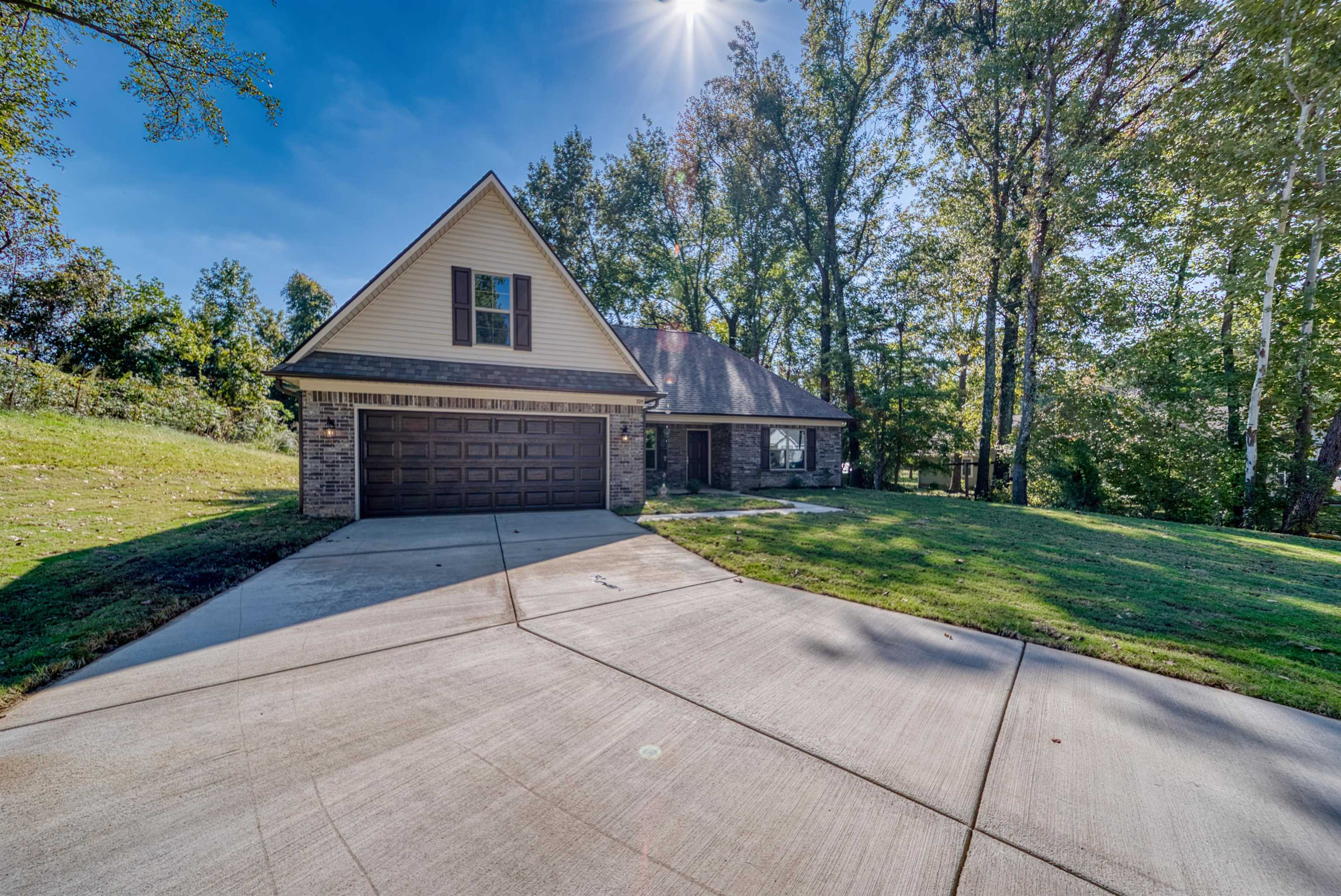 109 Walnut Ridge Ripley, TN 38063 - Photo 32 of 39 a front view of a house with a yard and garage