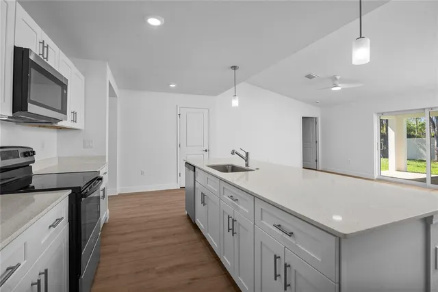 a kitchen with a sink microwave and stove