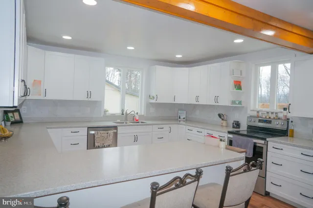 a kitchen with a sink a stove and cabinets