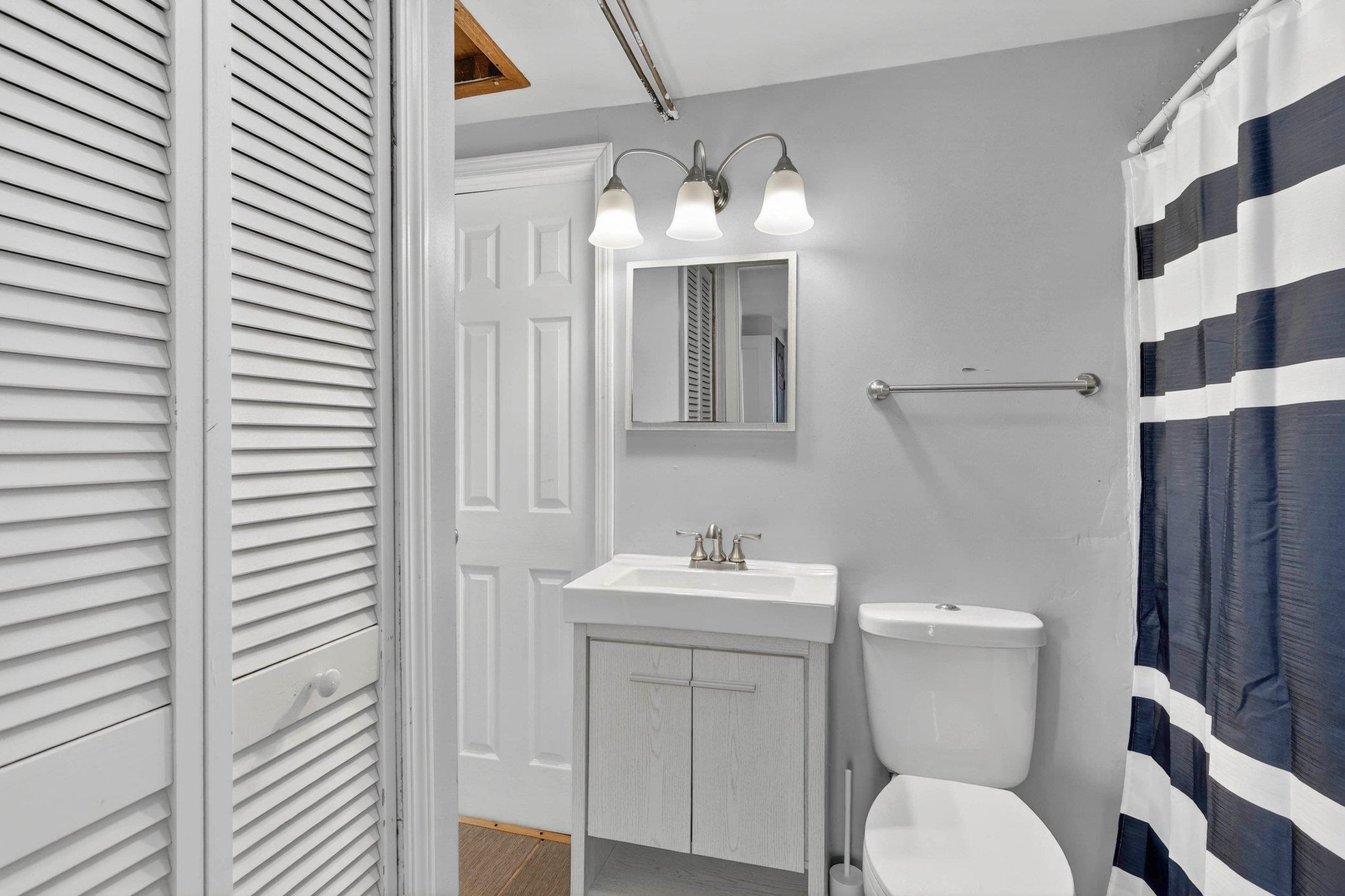 2120 Belden Street Rockford, IL 61101 - Photo 15 of 22 a bathroom with a toilet a sink and mirror
