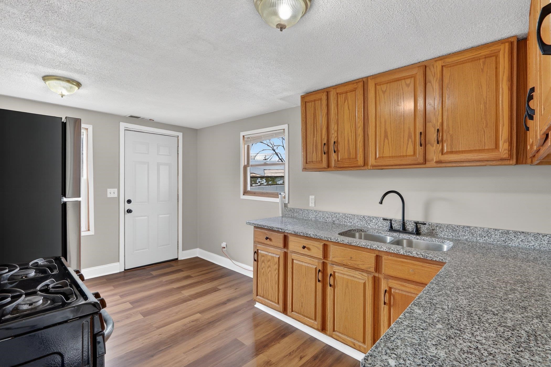 2120 Belden Street Rockford, IL 61101 - Photo 9 of 22 a kitchen with stainless steel appliances granite countertop a sink stove and cabinets