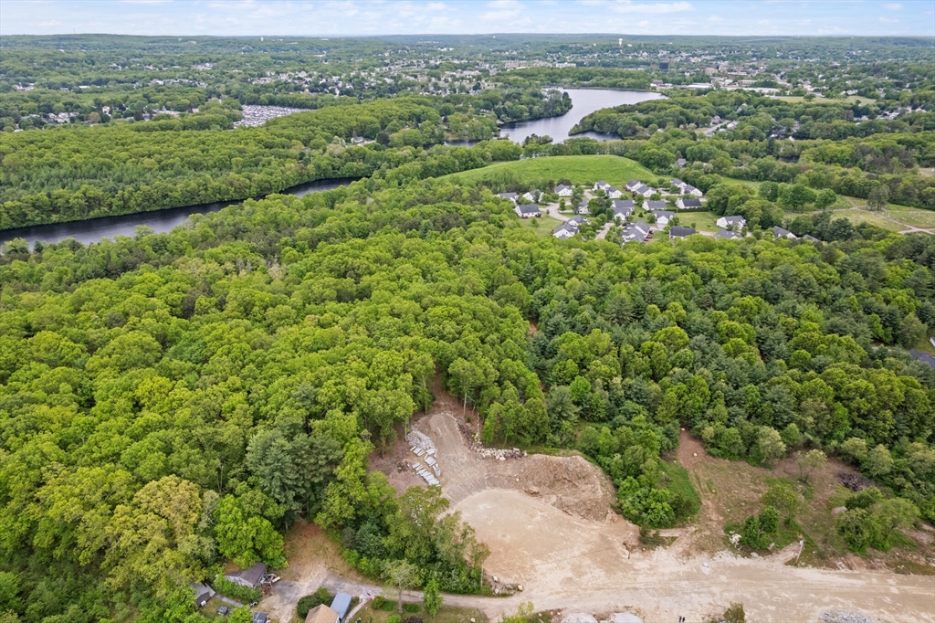 Lot 3 Pickering Road Blackstone, MA 01504 - Photo 4 of 4 an aerial view of a houses with a lush green hillside