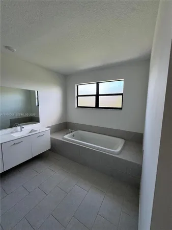 a bathroom with a tub a toilet and a bathtub