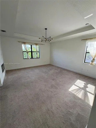 a view of a room with a ceiling fan