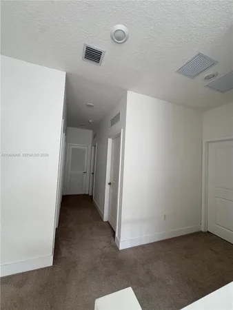 a utility room with a sink a vanity and mirror