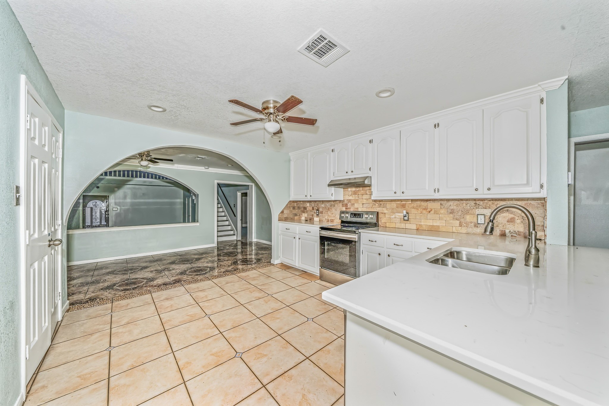 4771 Teas Court Conroe, TX 77304 - Photo 12 of 37 a kitchen with a stove a sink and cabinets