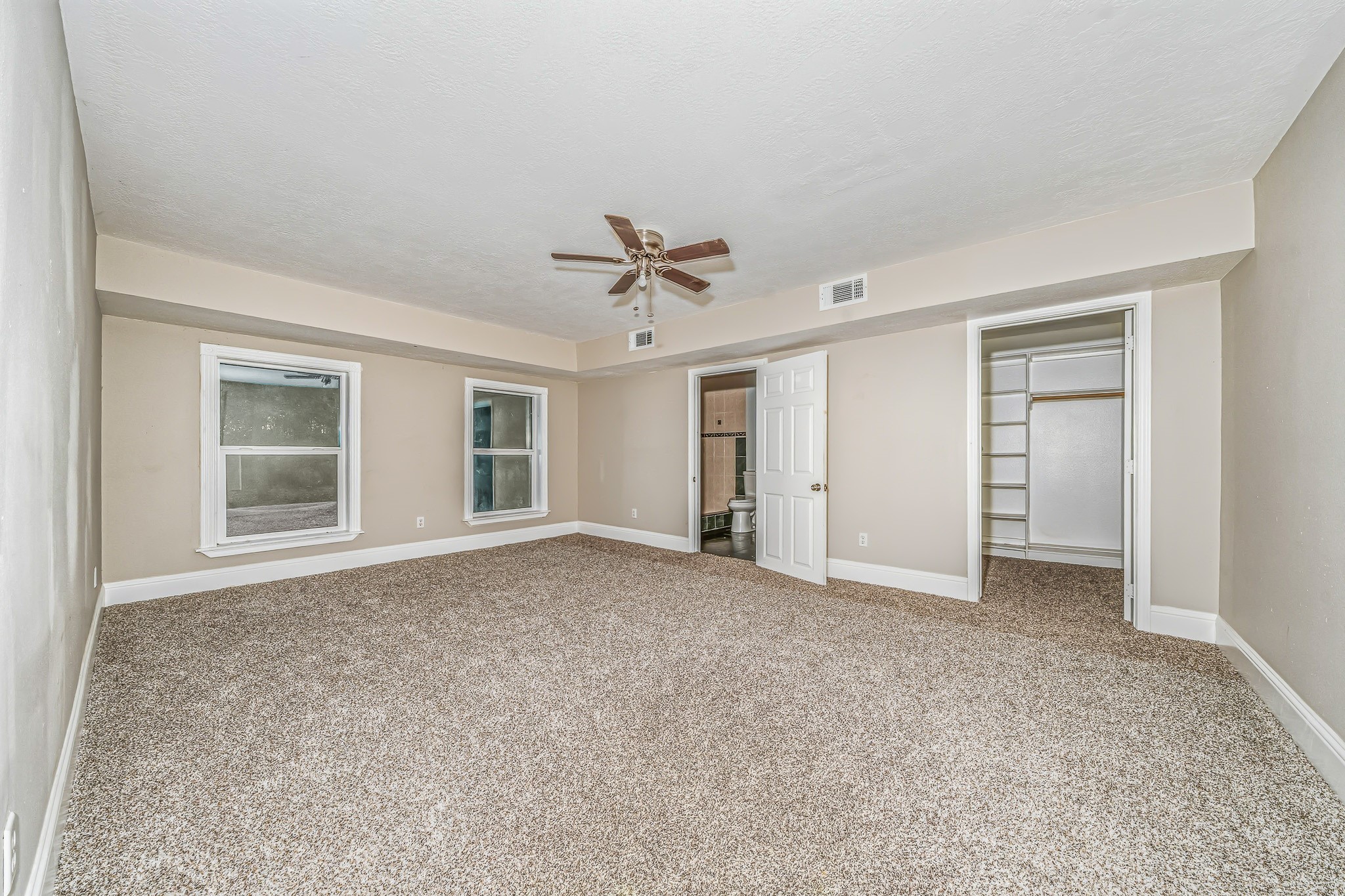 4771 Teas Court Conroe, TX 77304 - Photo 22 of 37 an empty room with a ceiling fan and a window