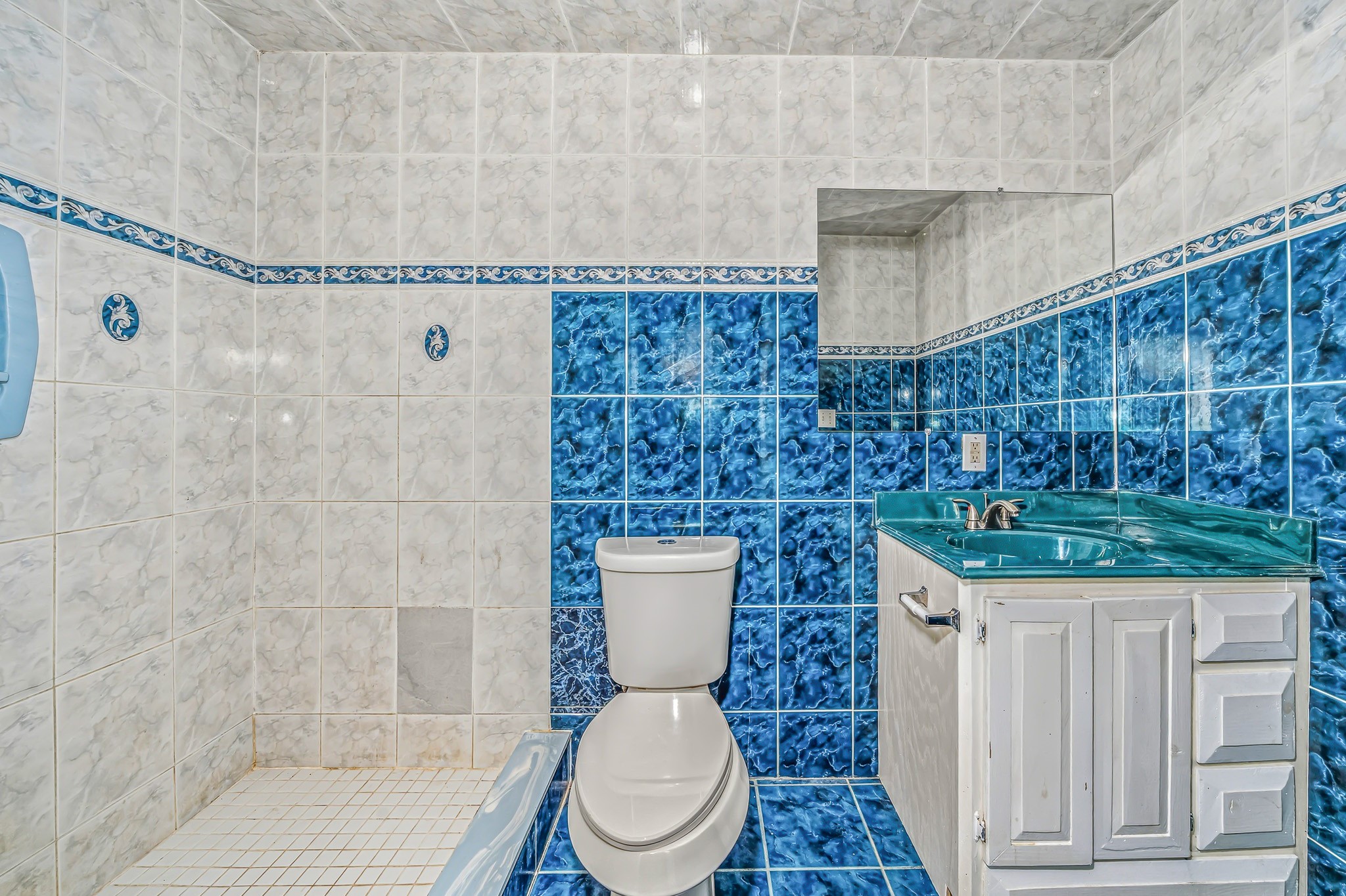 4771 Teas Court Conroe, TX 77304 - Photo 28 of 37 a bathroom with a granite countertop toilet a sink and a shower