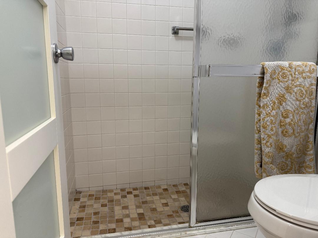 6217 Stanley Lane Delray Beach, FL 33484 - Photo 13 of 26 a bathroom with a shower and toilet