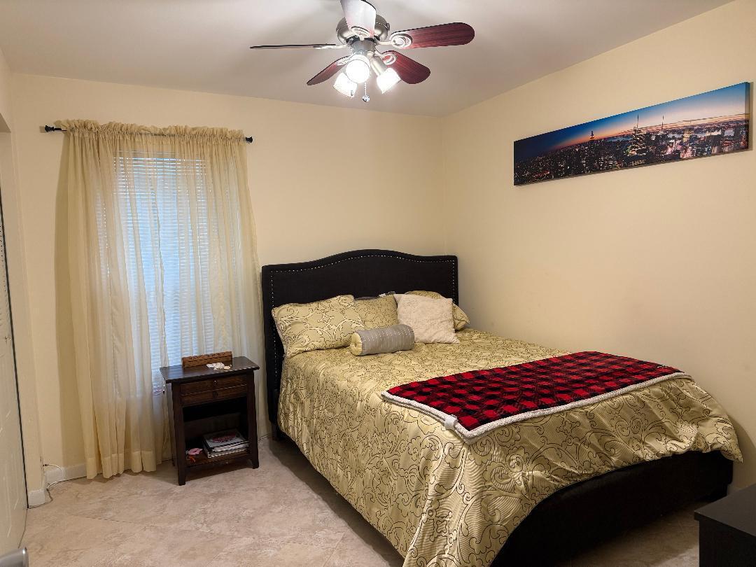 6217 Stanley Lane Delray Beach, FL 33484 - Photo 15 of 26 a bedroom with a bed and a window