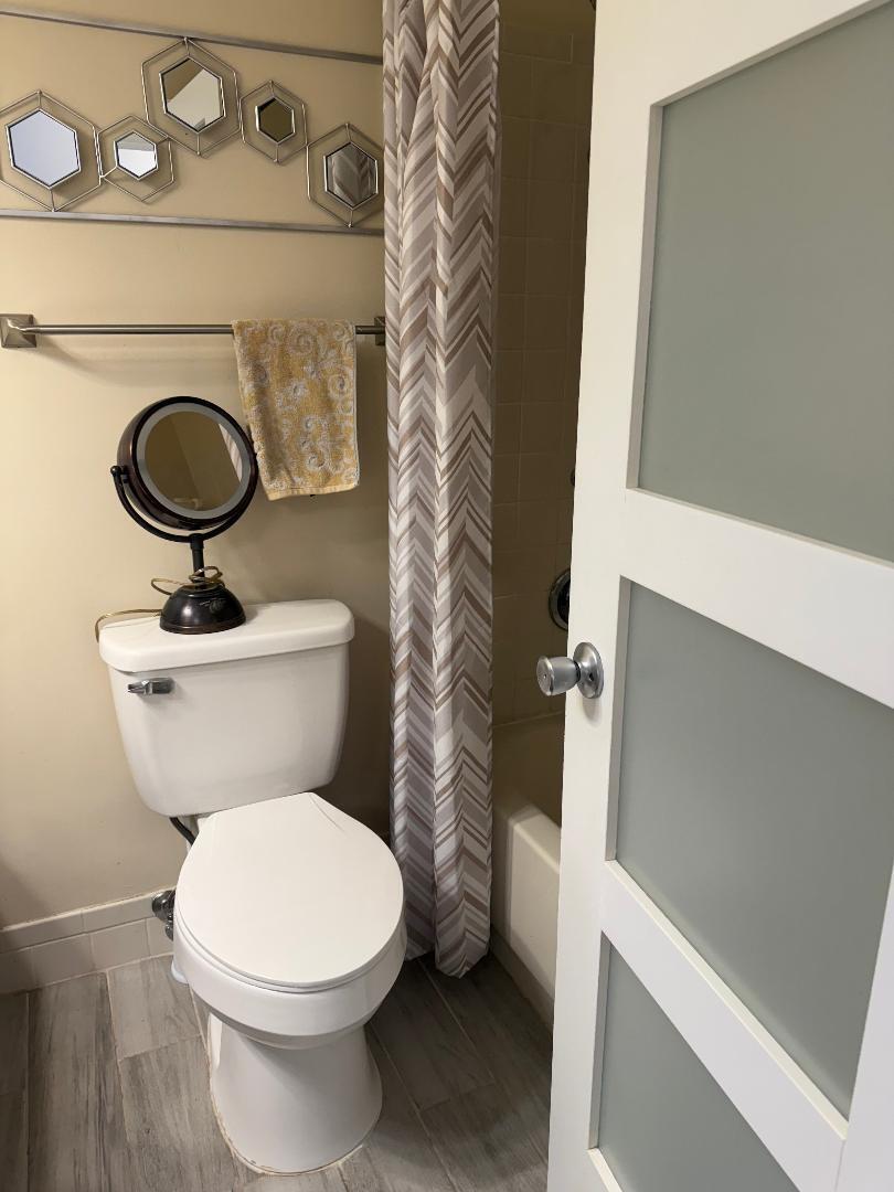 6217 Stanley Lane Delray Beach, FL 33484 - Photo 17 of 26 a bathroom with a toilet a sink and a mirror