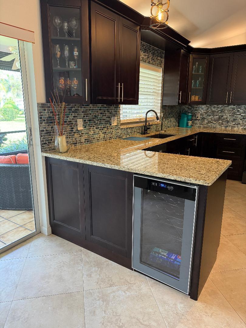 6217 Stanley Lane Delray Beach, FL 33484 - Photo 4 of 26 a kitchen with granite countertop a sink and a stove