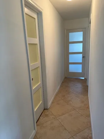 an empty room with closet and mirror