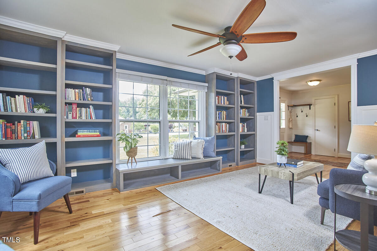 1502 Cassandra Drive Durham, NC 27712 - Photo 11 of 52 a living room with furniture and a book shelf