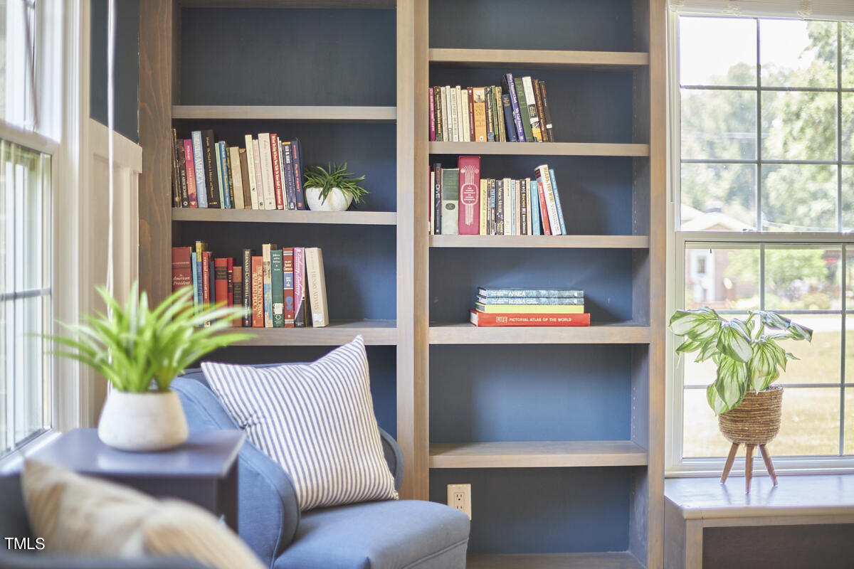 1502 Cassandra Drive Durham, NC 27712 - Photo 12 of 52 a living room with furniture and a book shelf