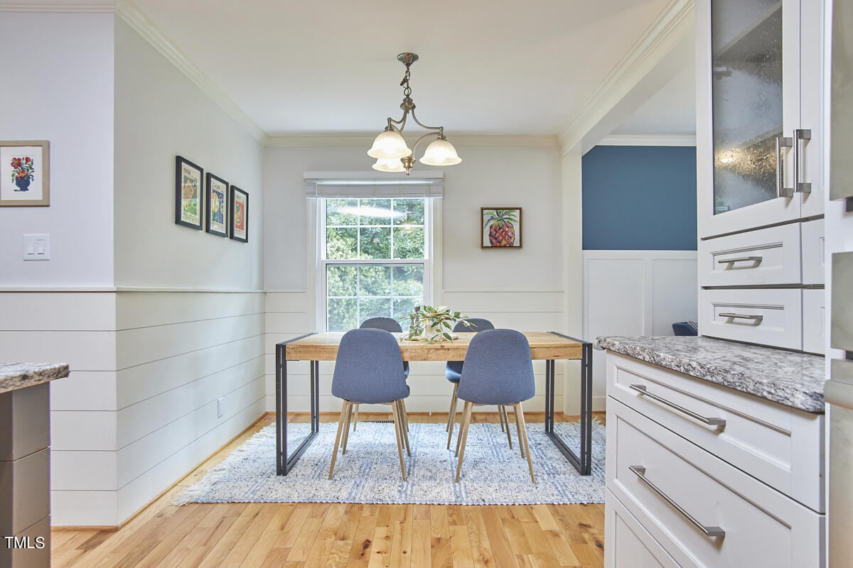 1502 Cassandra Drive Durham, NC 27712 - Photo 16 of 52 a view of a dining room with furniture and wooden floor