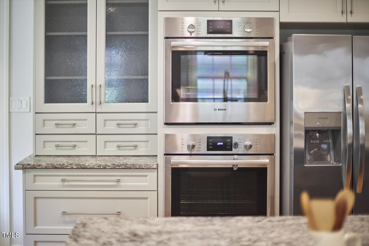1502 Cassandra Drive Durham, NC 27712 - Photo 21 of 52 a kitchen with stainless steel appliances granite countertop a stove and a refrigerator