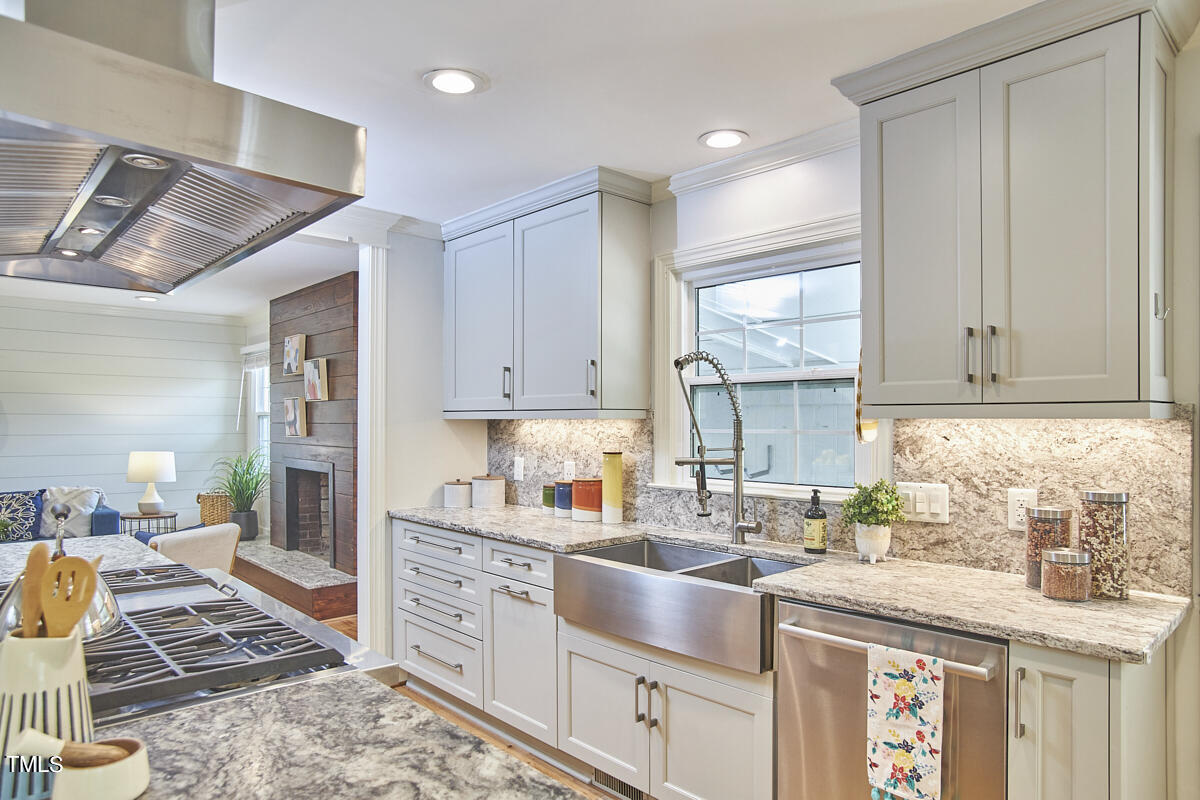 1502 Cassandra Drive Durham, NC 27712 - Photo 22 of 52 a kitchen with stainless steel appliances granite countertop a sink stove and cabinets