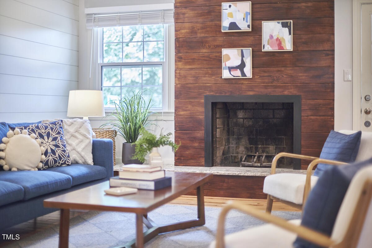 1502 Cassandra Drive Durham, NC 27712 - Photo 27 of 52 a living room with furniture and a fireplace