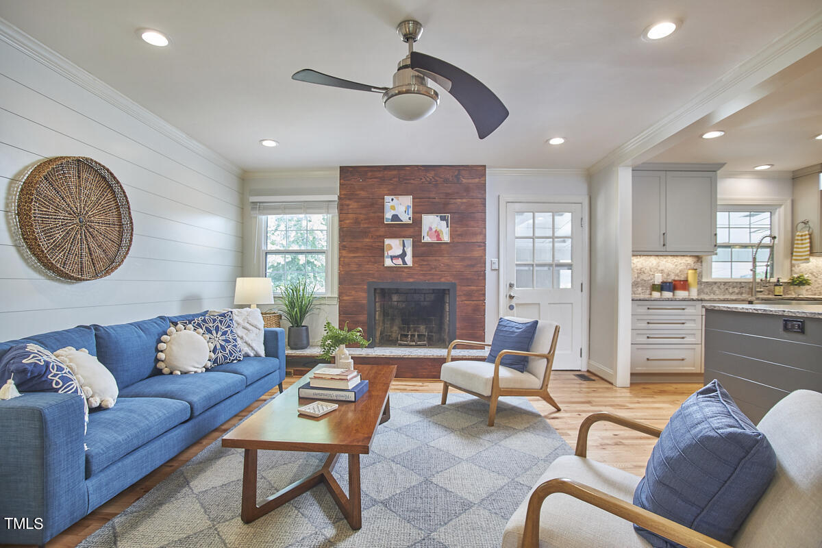 1502 Cassandra Drive Durham, NC 27712 - Photo 28 of 52 a living room with furniture and a fireplace