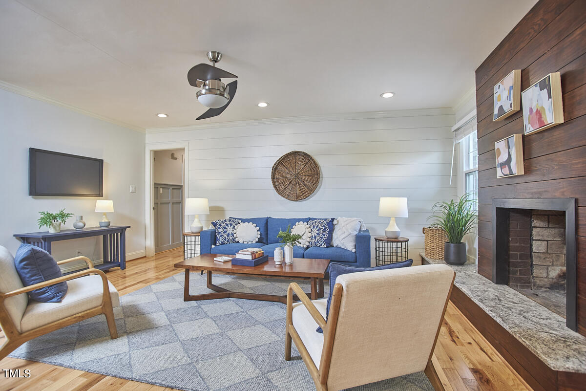 1502 Cassandra Drive Durham, NC 27712 - Photo 30 of 52 a living room with fireplace furniture and a flat screen tv