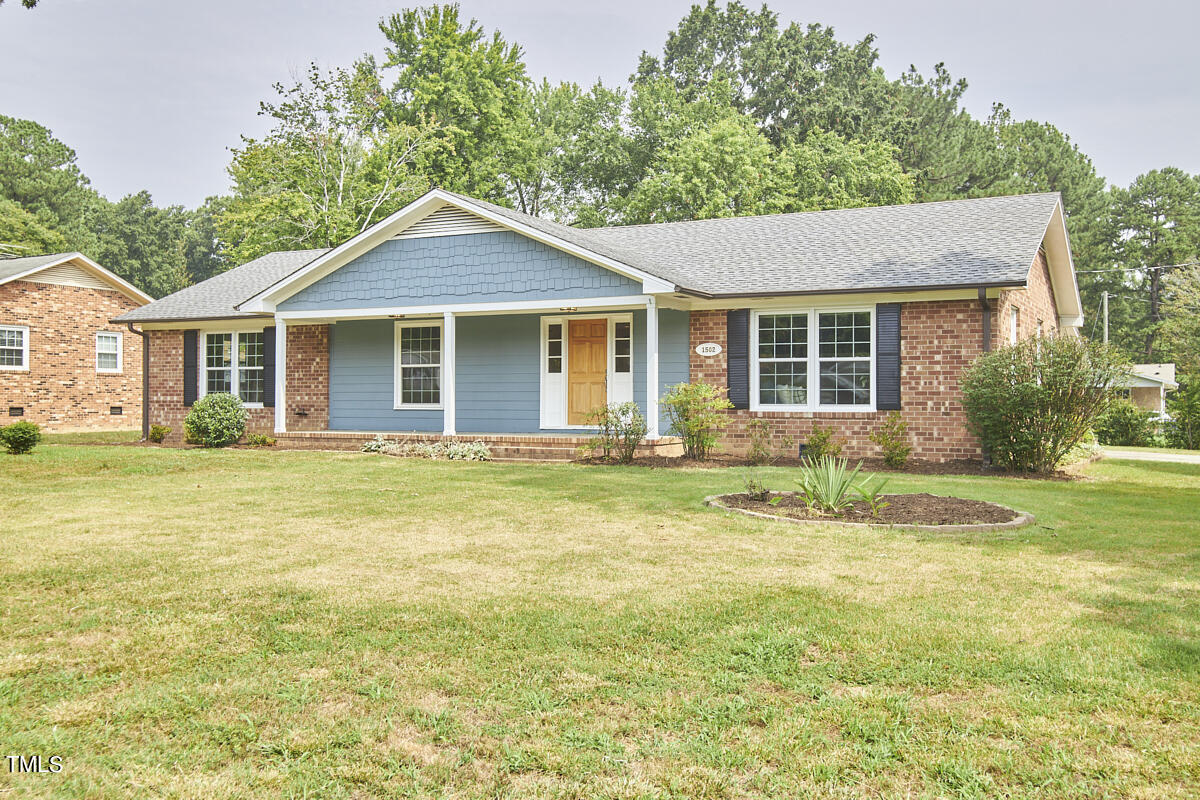 1502 Cassandra Drive Durham, NC 27712 - Photo 3 of 52 a front view of a house with a yard