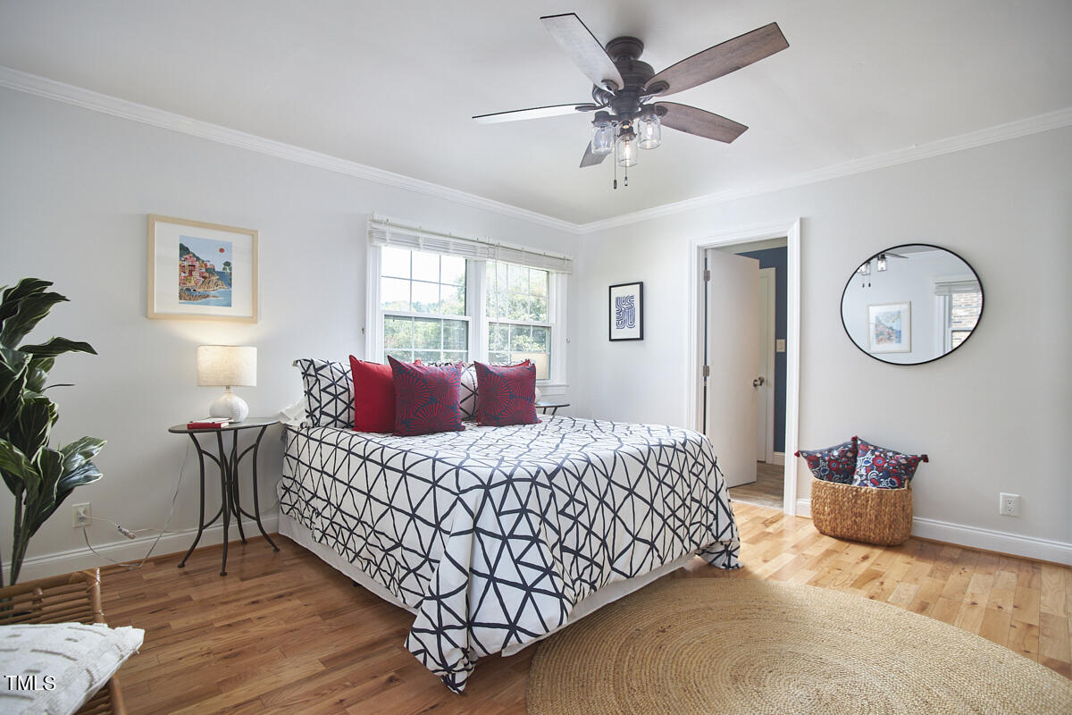 1502 Cassandra Drive Durham, NC 27712 - Photo 35 of 52 a bedroom with a bed dresser and a window