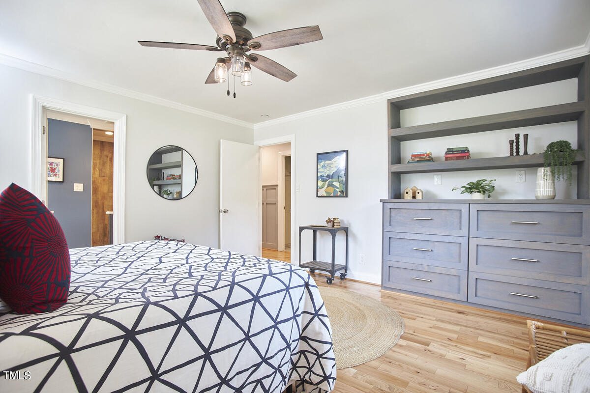 1502 Cassandra Drive Durham, NC 27712 - Photo 37 of 52 a bedroom with a large bed and a chandelier