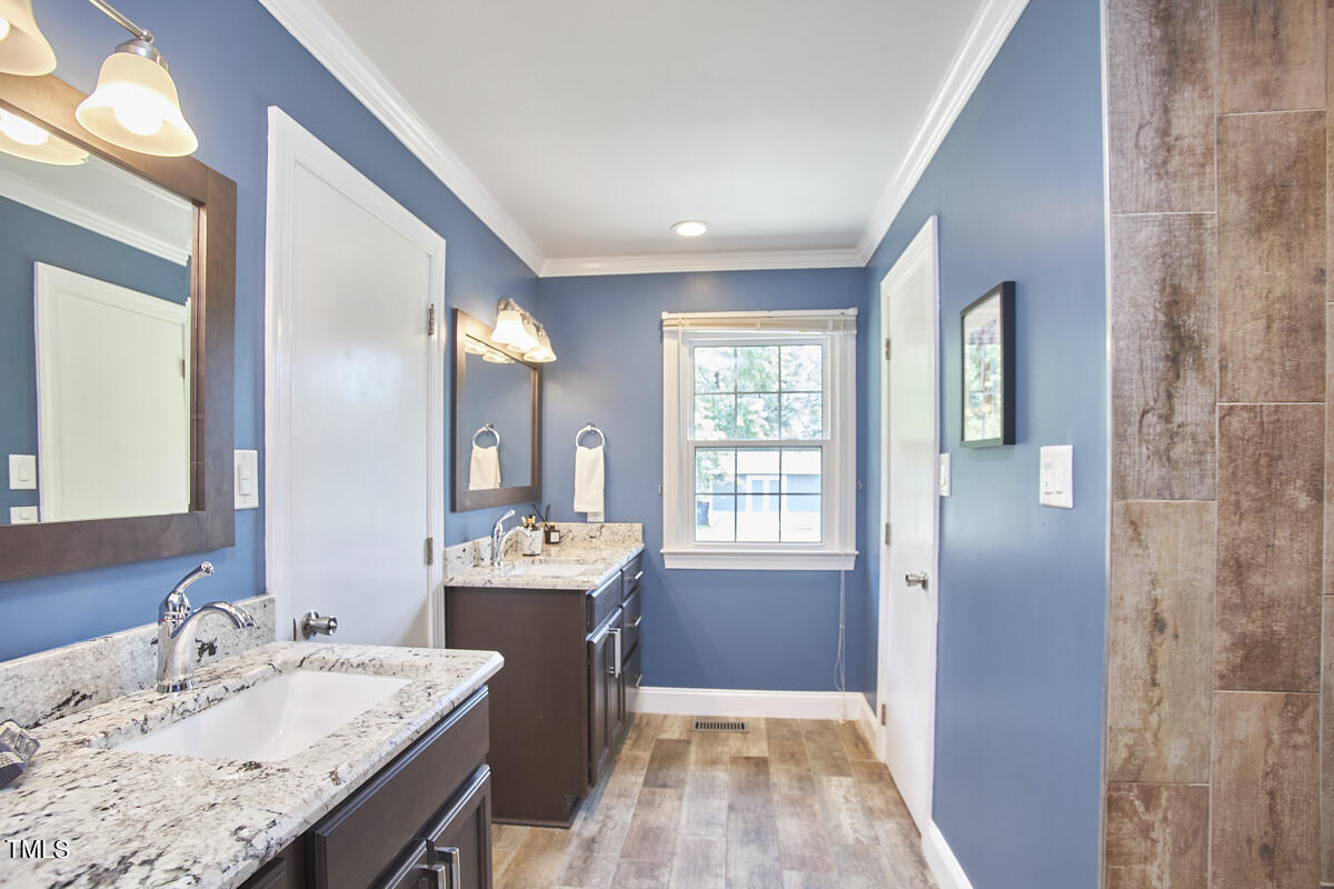 1502 Cassandra Drive Durham, NC 27712 - Photo 38 of 52 a bathroom with a sink double vanity granite tub and shower