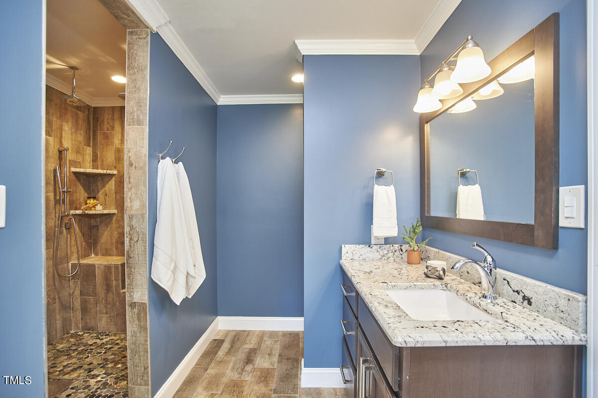 1502 Cassandra Drive Durham, NC 27712 - Photo 41 of 52 a bathroom with a granite countertop sink and a mirror