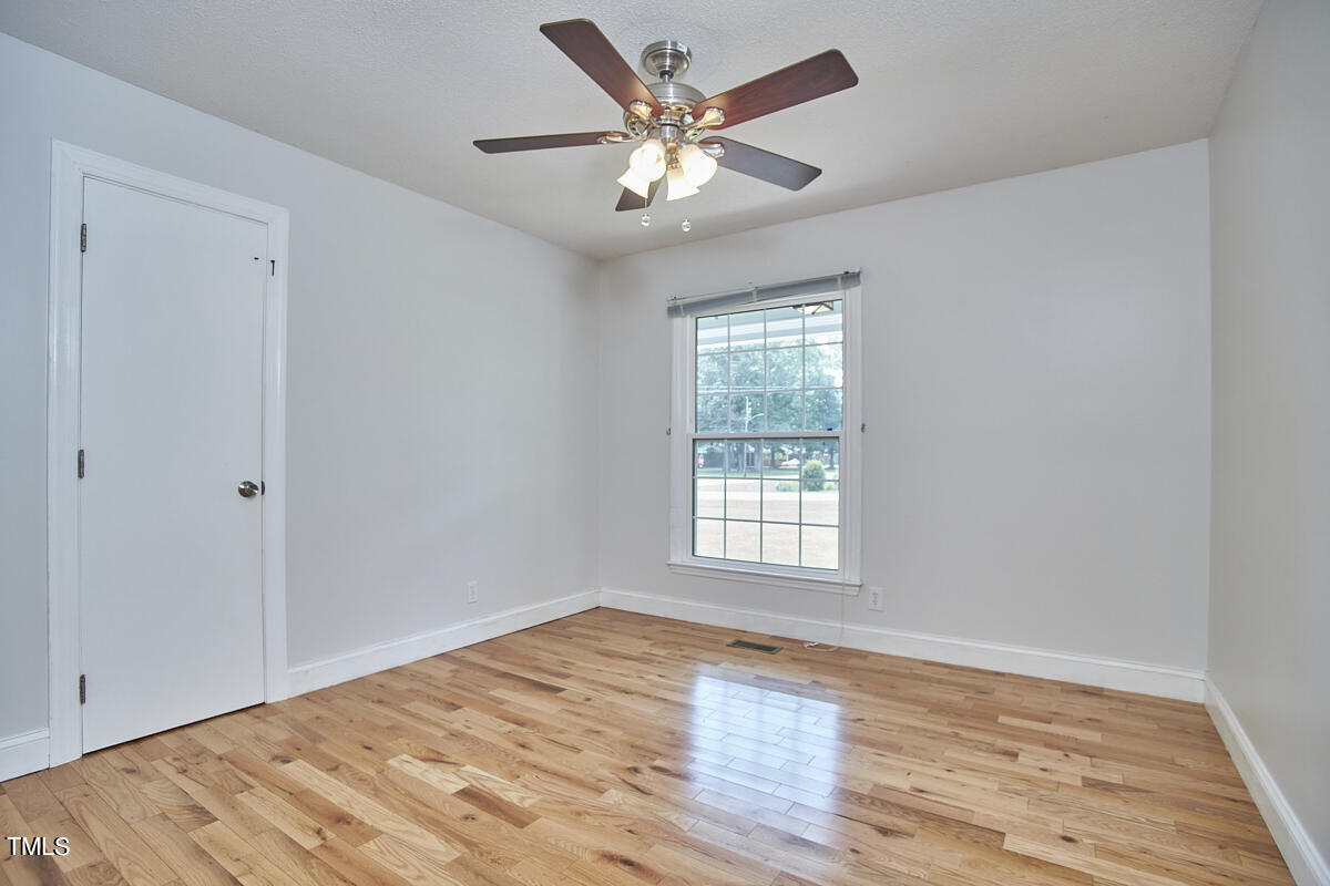 1502 Cassandra Drive Durham, NC 27712 - Photo 44 of 52 an empty room with wooden floor and windows