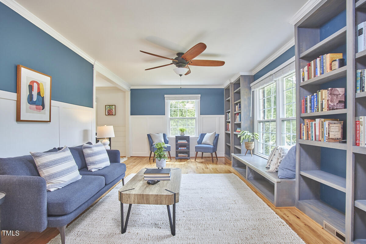 1502 Cassandra Drive Durham, NC 27712 - Photo 8 of 52 a living room with furniture a bookshelf and a window