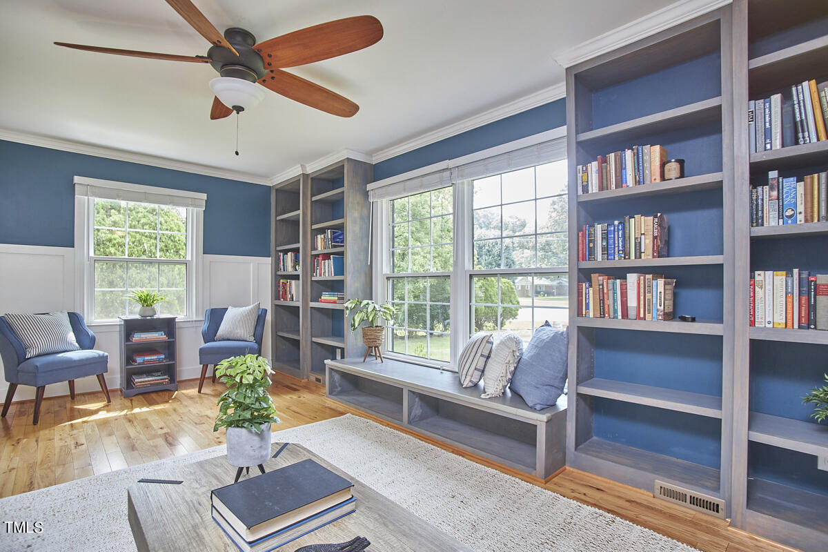 1502 Cassandra Drive Durham, NC 27712 - Photo 10 of 52 a living room with furniture bookshelf and a window