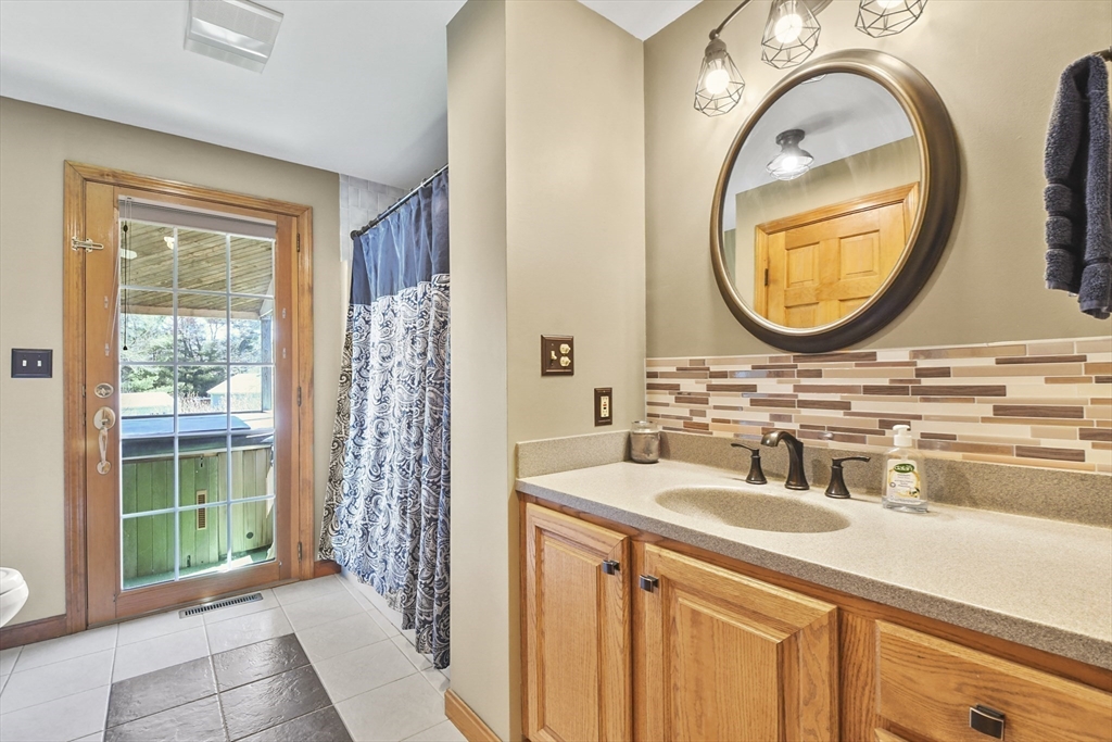 325 Mendall Road Acushnet, MA 02743 - Photo 17 of 42 a bathroom with a sink a mirror a vanity and a window