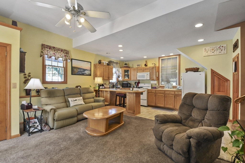 325 Mendall Road Acushnet, MA 02743 - Photo 31 of 42 a living room with furniture kitchen and a chandelier