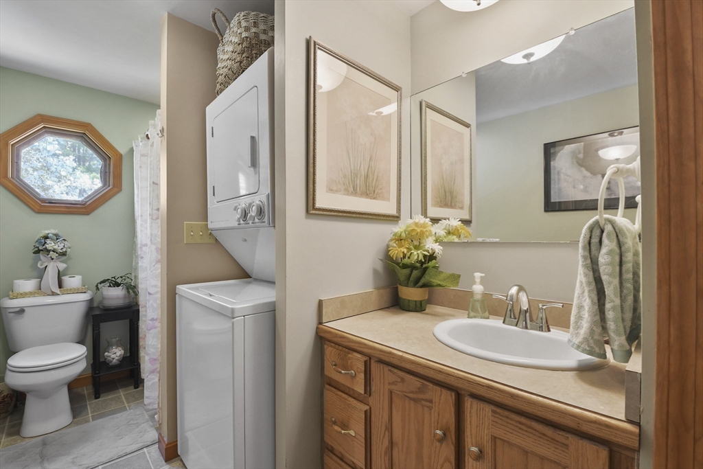 325 Mendall Road Acushnet, MA 02743 - Photo 32 of 42 a bathroom with a granite countertop sink a toilet and a mirror