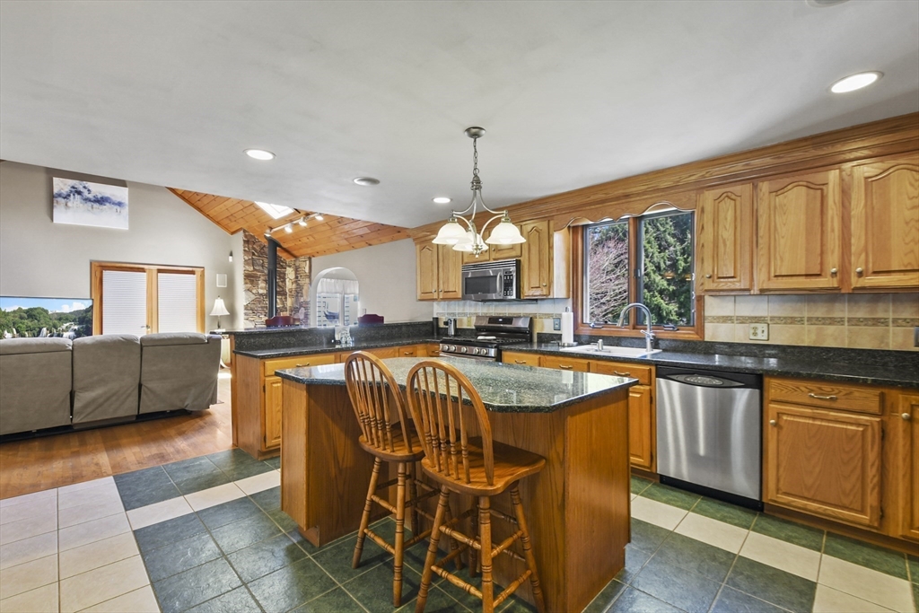 325 Mendall Road Acushnet, MA 02743 - Photo 6 of 42 a dining hall with stainless steel appliances granite countertop a sink a counter space and a living room view