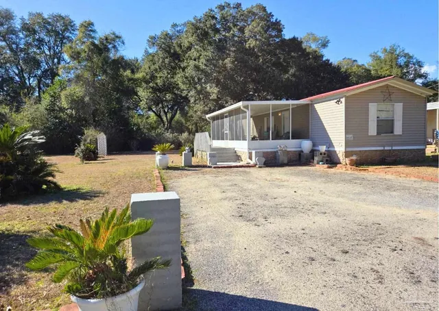 a view of a house with snow on the side of the road