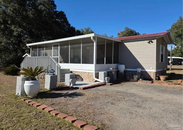 a view of a patio with table and chairs and potted plants