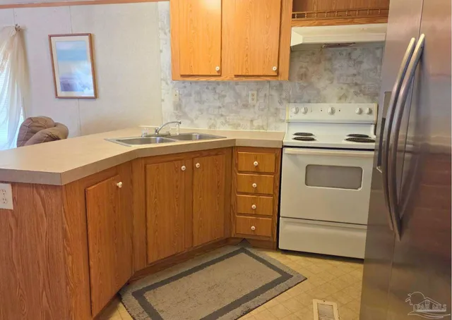a kitchen with a sink stove and cabinets