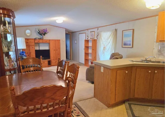 a living room with furniture a window and a flat screen tv
