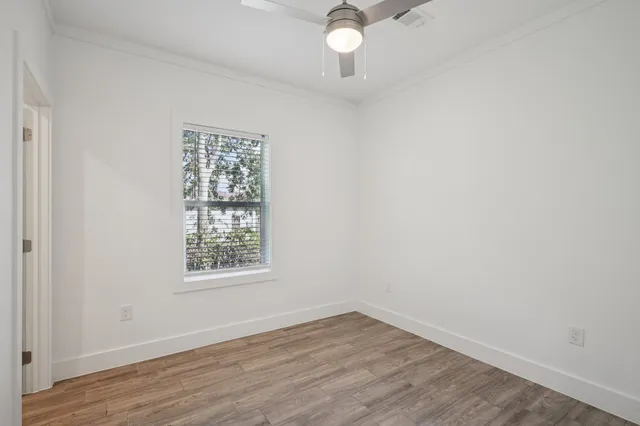 wooden floor in an empty room with a window