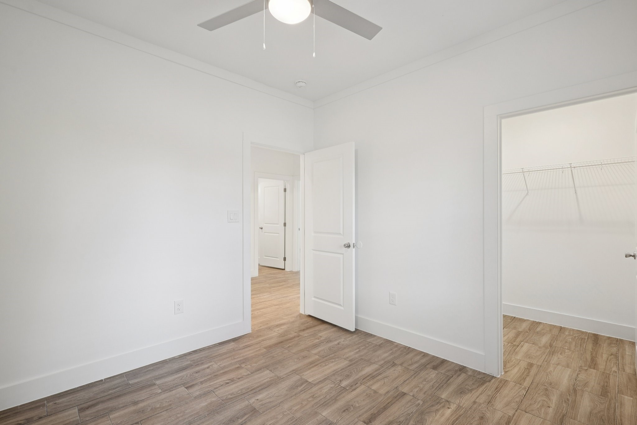 3917 Sayers Street Houston, TX 77026 - Photo 13 of 26 an empty room with wooden floor and ceiling fan