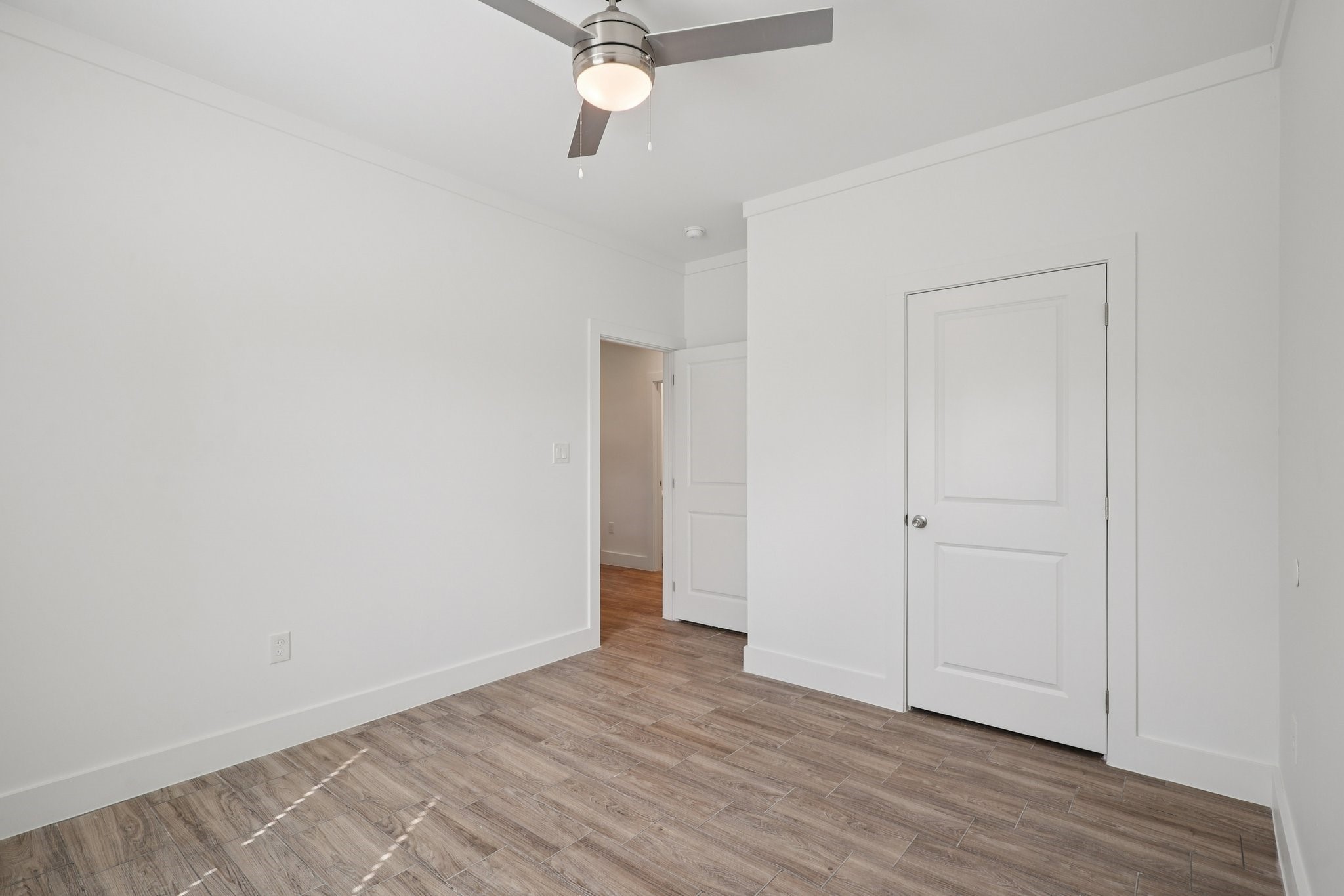 3917 Sayers Street Houston, TX 77026 - Photo 15 of 26 a view of a room with wooden floor and fan
